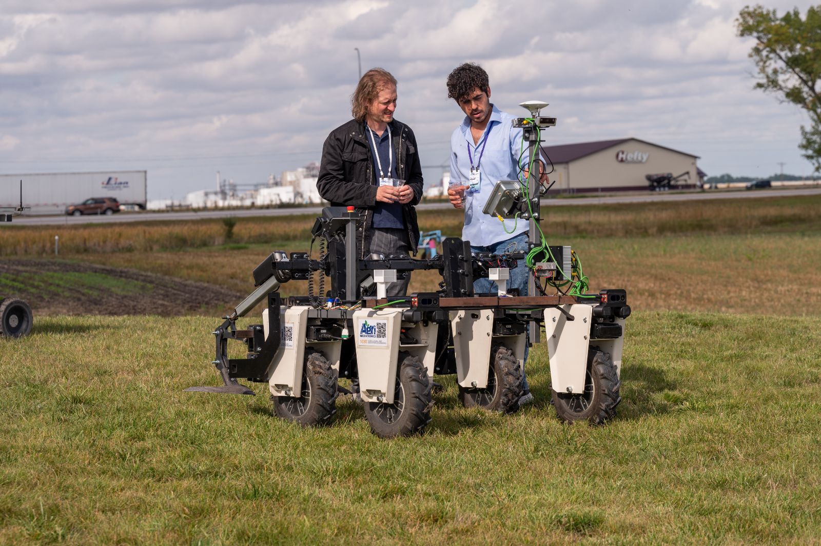 Explaining the weeding robot to a visitor