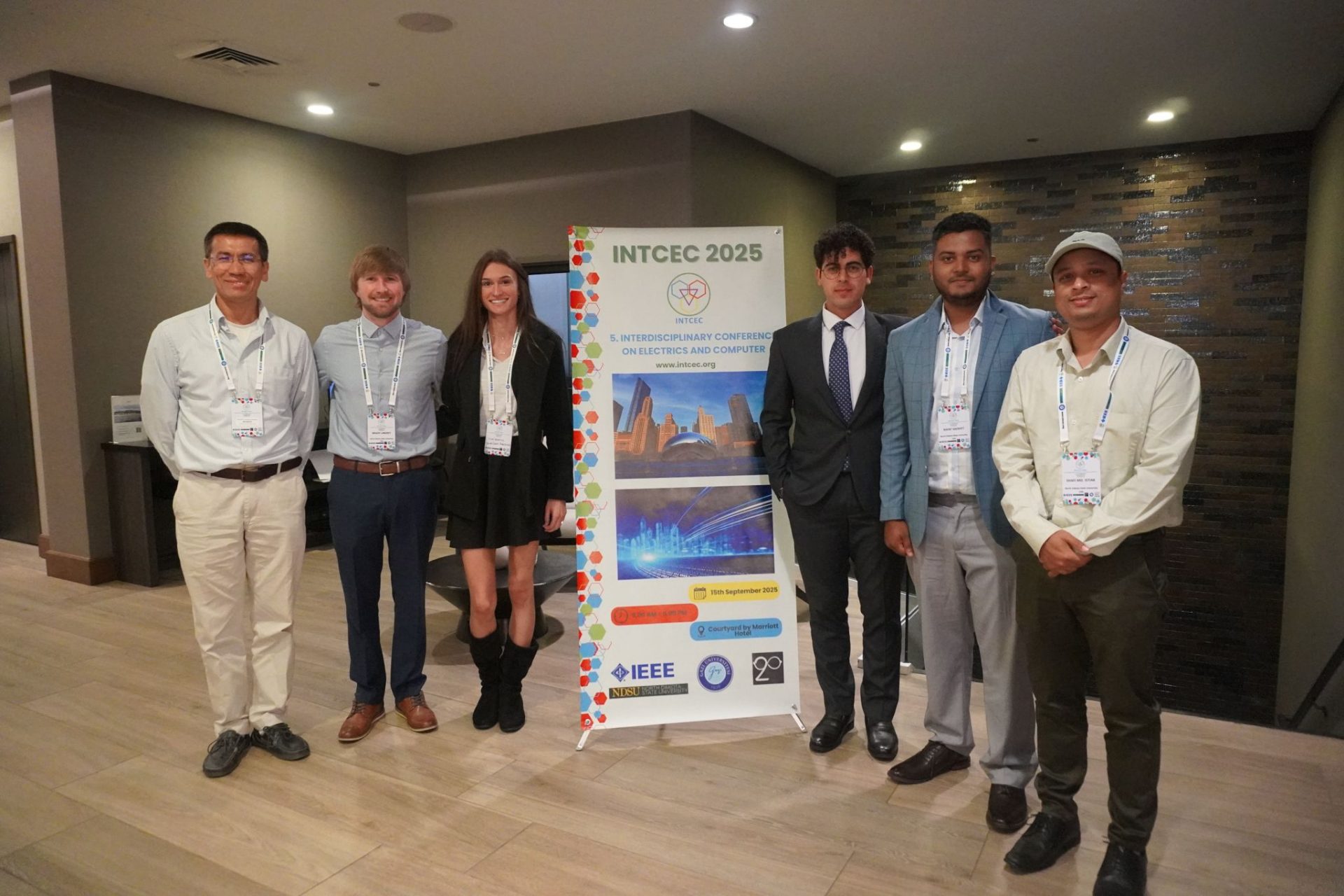 Team at INTCEC 2025 banner, Chicago